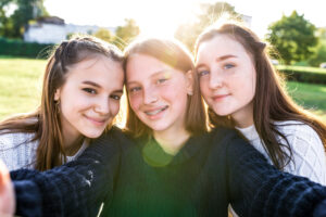 3 girls schoolgirls, selfie photo on phone camera,